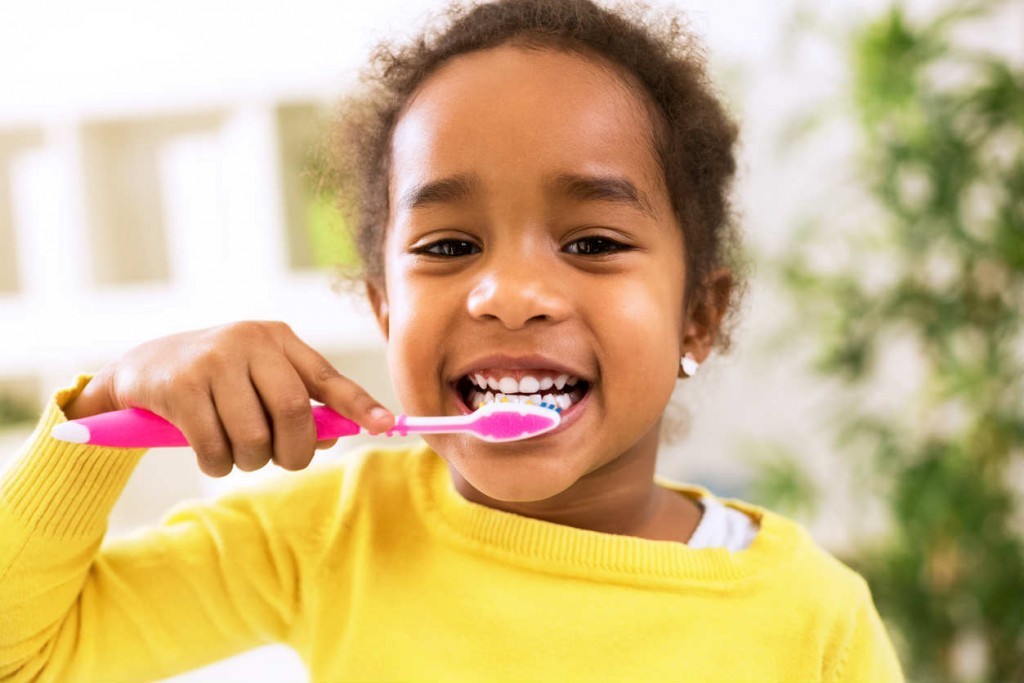 St. Louis girl brushing her teeth