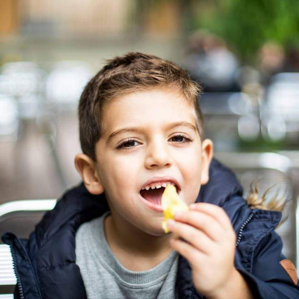 child eating chips