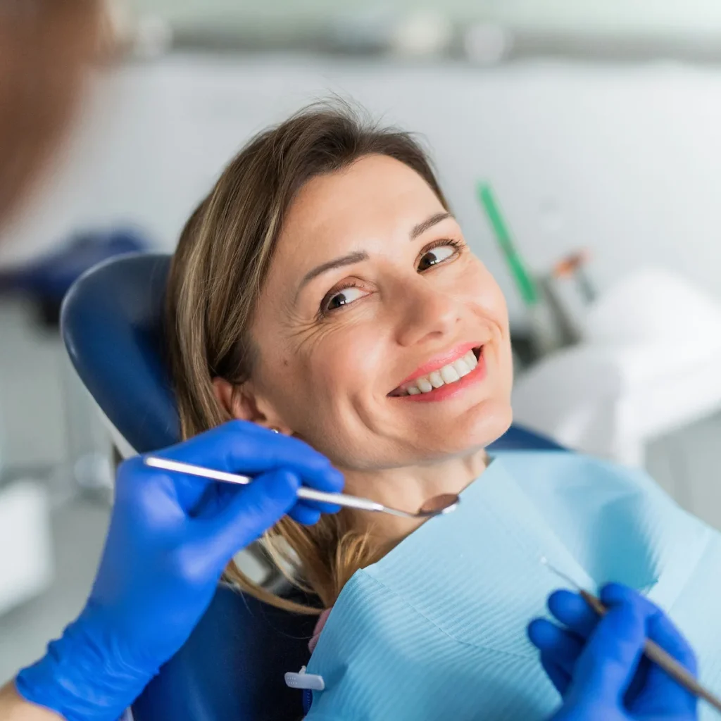  Smiling woman receiving gentle dental care in a modern St. Charles area clinic.